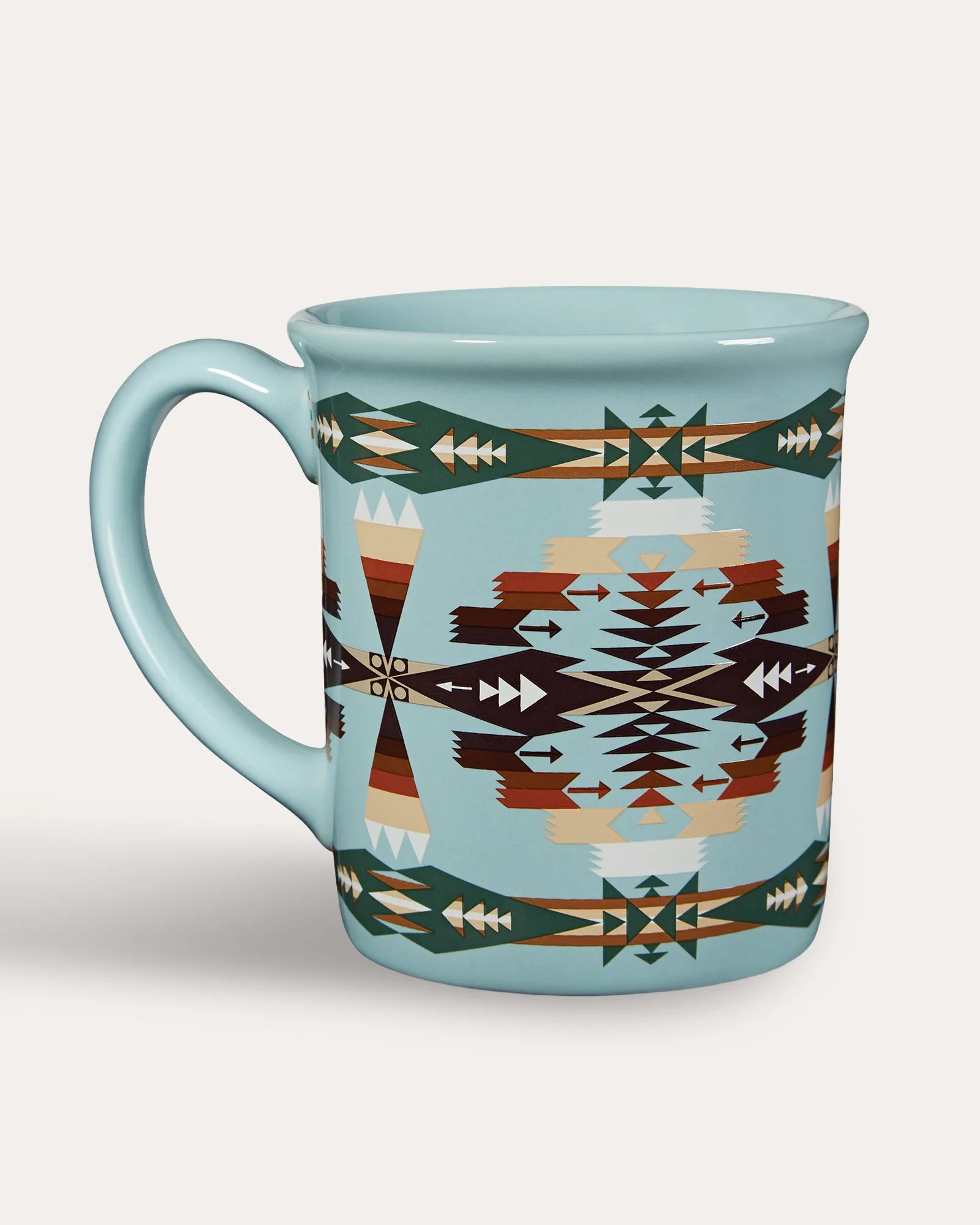 A ceramic mug with a light blue base and a Southwestern geometric pattern featuring brown, beige, and dark green motifs, set against a plain light gray background. Made by Pendleton USA