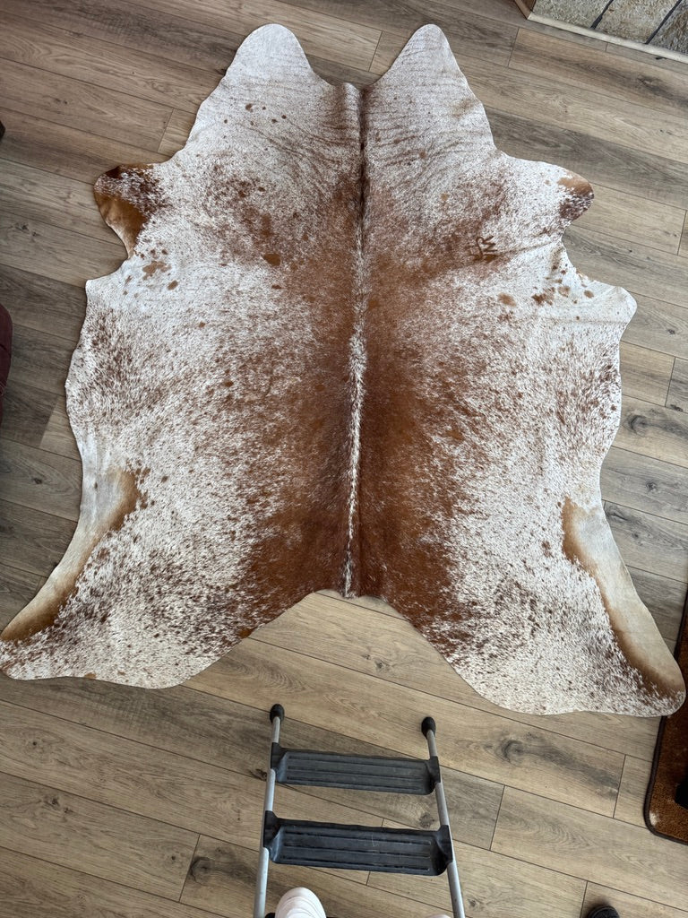 White and brown peppered cowhide with ranch brand