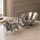 Decorative silver reindeer with sleigh on a marble surface