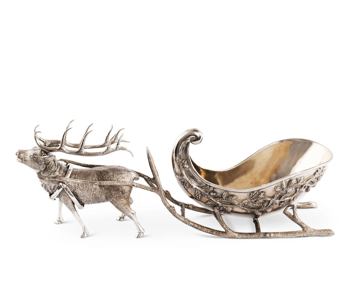 Decorative silver reindeer pulling a sleigh on a white background