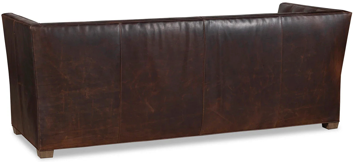 Modern rustic tufted leather sofa with tailored silhouette, back view