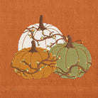 Embroidered pumpkins on a burnt orange fabric background - Your Western Decor
