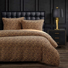 Bedroom with leopard print bedding, black upholstered headboard, and gold lamp - Your Western Decor
