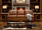 Brown leather sofa in a living room with wooden shelves, lamps, and a fireplace