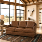 Rambler brown leather sofa in open ranch themed space with southwestern rug and buffalo skull wall mount 