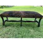 Full dark brindle cowhide upholstered bench with hand carved frame and nail trim