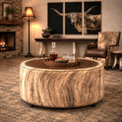 American Made Ranchland Cowhide Cocktail Ottoman Styled with Western Leather Accent Chair, cowhide accent tables, iron spur lamp with rawhide shade, and Longhorn triptych art