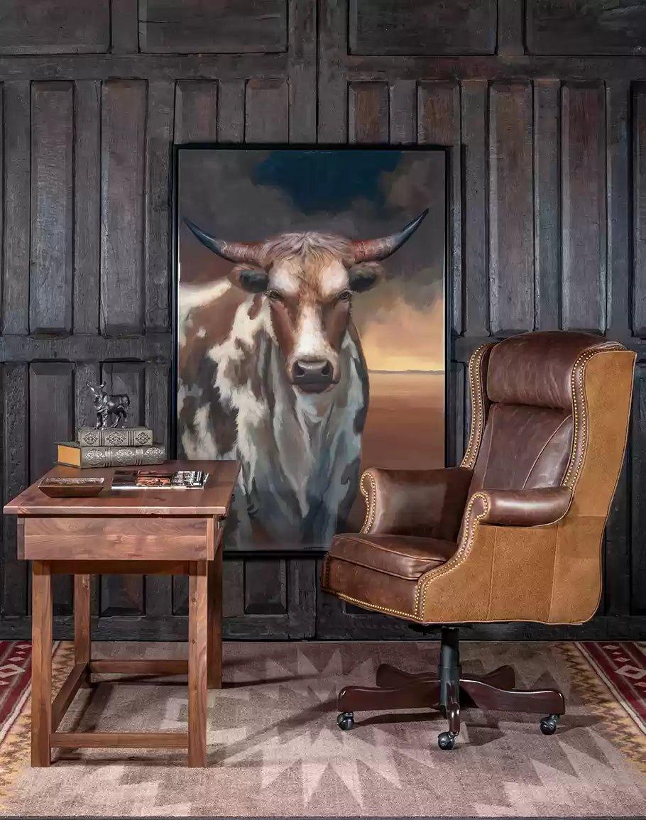 Rustic western office setting with leather executive chair, desk, rug and steer art - Your Western Decor