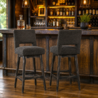 Raven Ridge faux shearling swivel bar stool with black chunky velvet upholstery and rustic hardwood base in luxury rustic industrial bar 