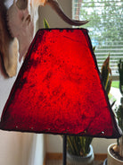 red rawhide lampshade end view with light on