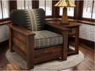 Wooden armchair with patterned cushion in a room with windows and a lamp.