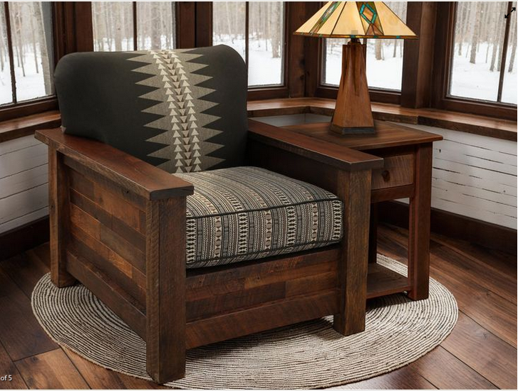 Wooden armchair with patterned cushion in a room with windows and a lamp.