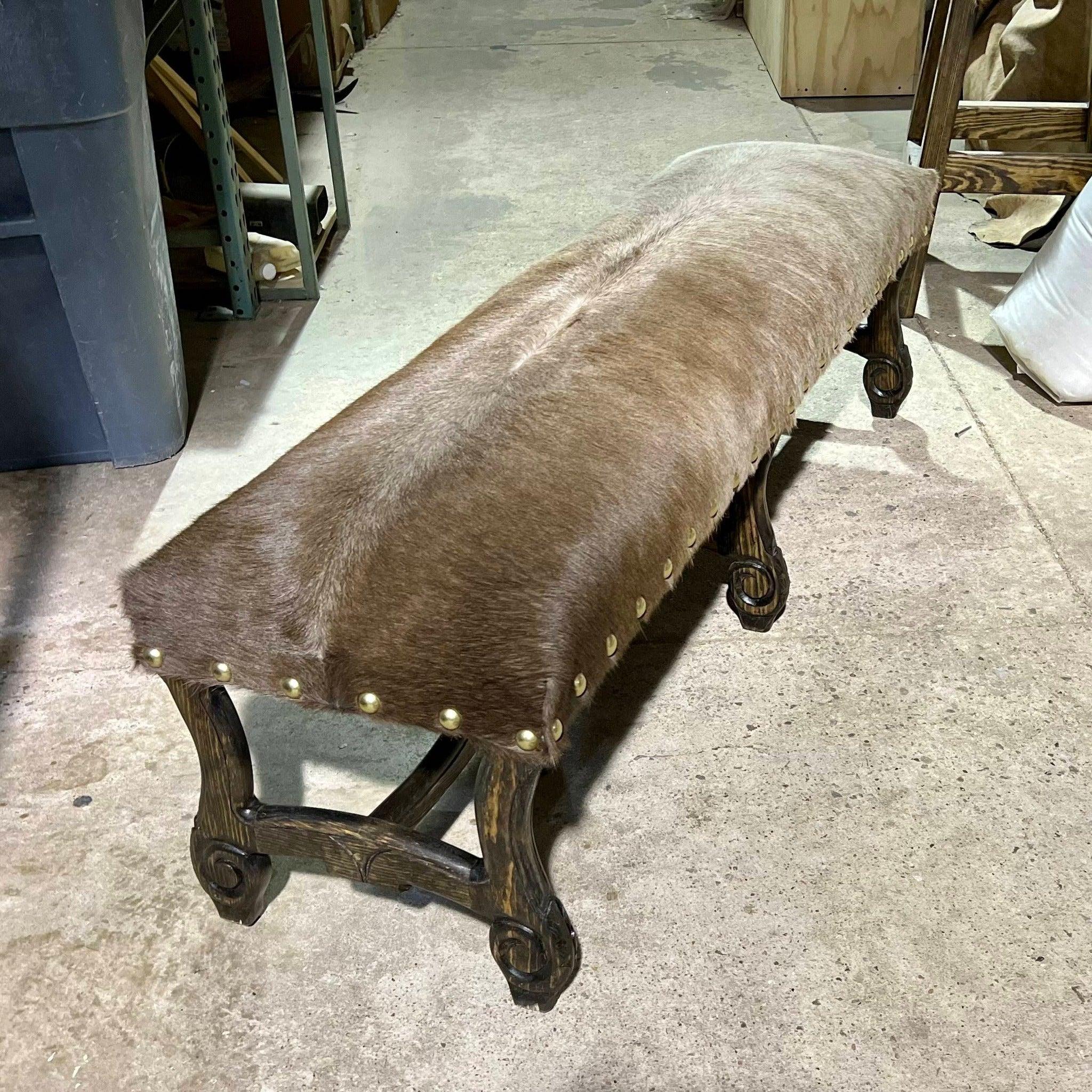 Fully cowhide upholstered bench with hand carved frame - Your Western Decor