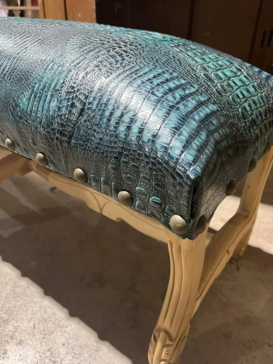 Turquoise croc embossed leather upholstery on hand carved bench frame 
