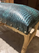 Turquoise croc embossed leather upholstery on hand carved bench frame 