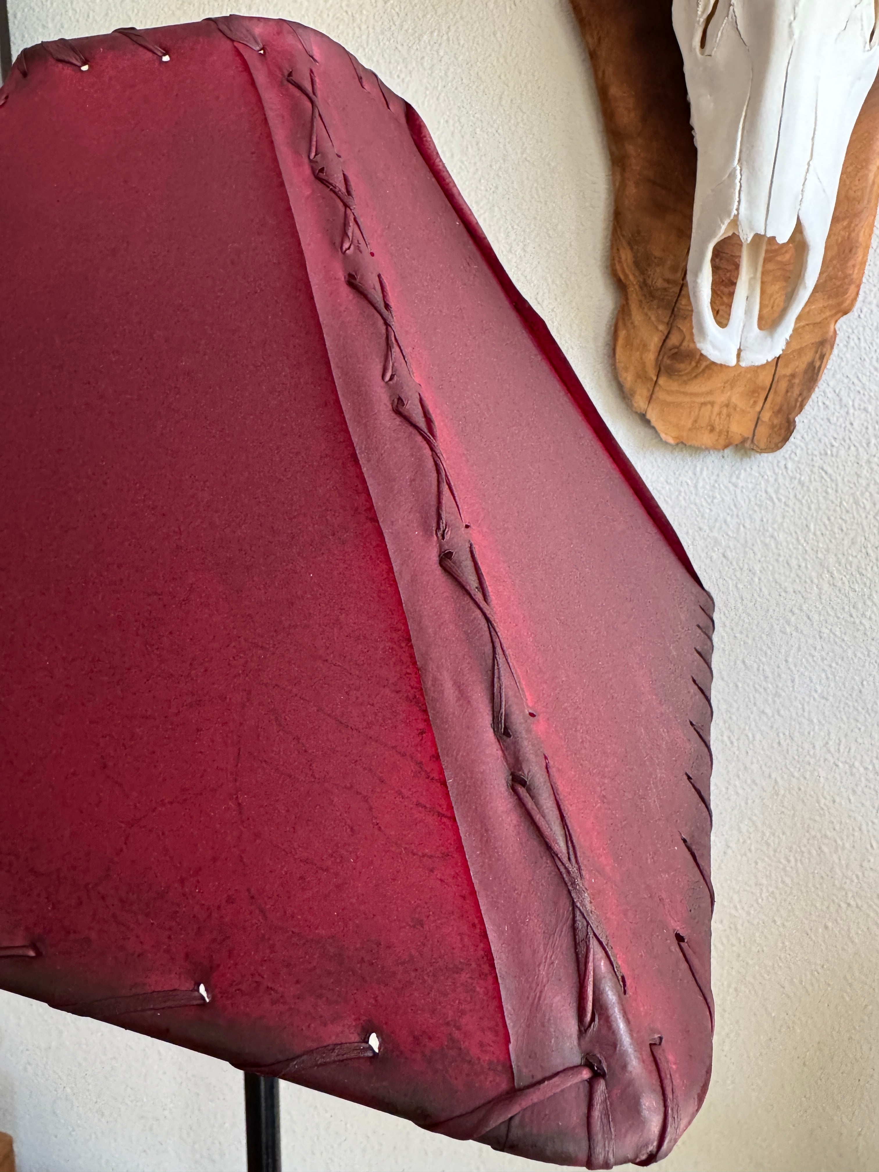 corner detail of red square rawhide lamp shade