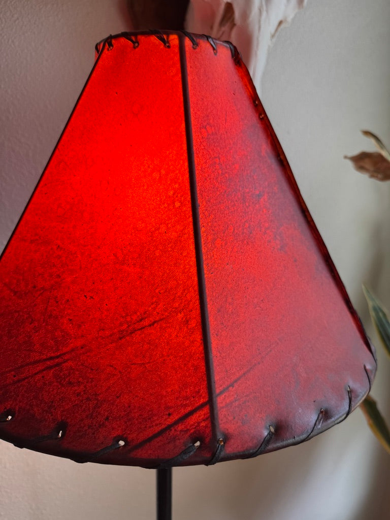 Round amber rawhide lamp shade with light on 