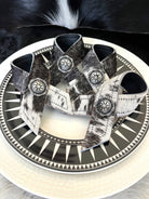 cowhide-napkin rings on black burst salad plate - Your Western Decor