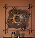 Decorative metal wall art with sun design on a terra cotta painted wall - Your Western Decor