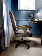 Alder wood and leather office chair in a room with a desk and lamp.
