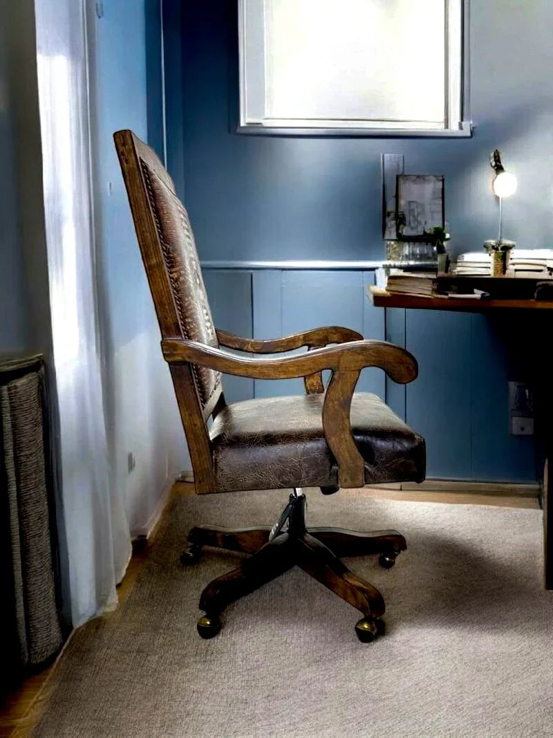Alder wood and leather office chair in a room with a desk and lamp.