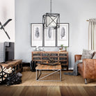 Living room with wooden furniture, a brown leather sofa, and decorative elements 