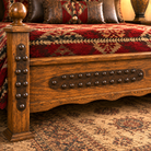 Handcrafted wood footboard with hand-forged blacksmith trim on Saddle Ridge Tooled Leather Bed