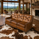 Luxury tufted leather sofa with hand-burnished leather upholstery in luxury open living area 