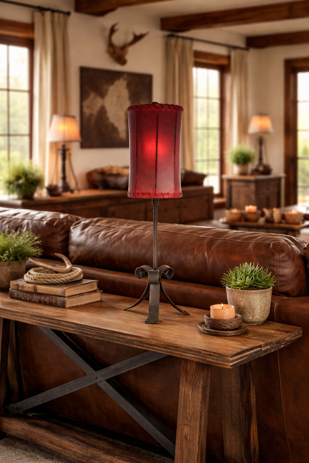 Cozy living room with brown leather sofa, wooden coffee table, decorative items and. iron table lamp with red rawhide lamp shade - Your Western Decor