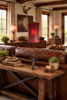 Cozy living room with brown leather sofa, wooden coffee table, decorative items and. iron table lamp with red rawhide lamp shade - Your Western Decor