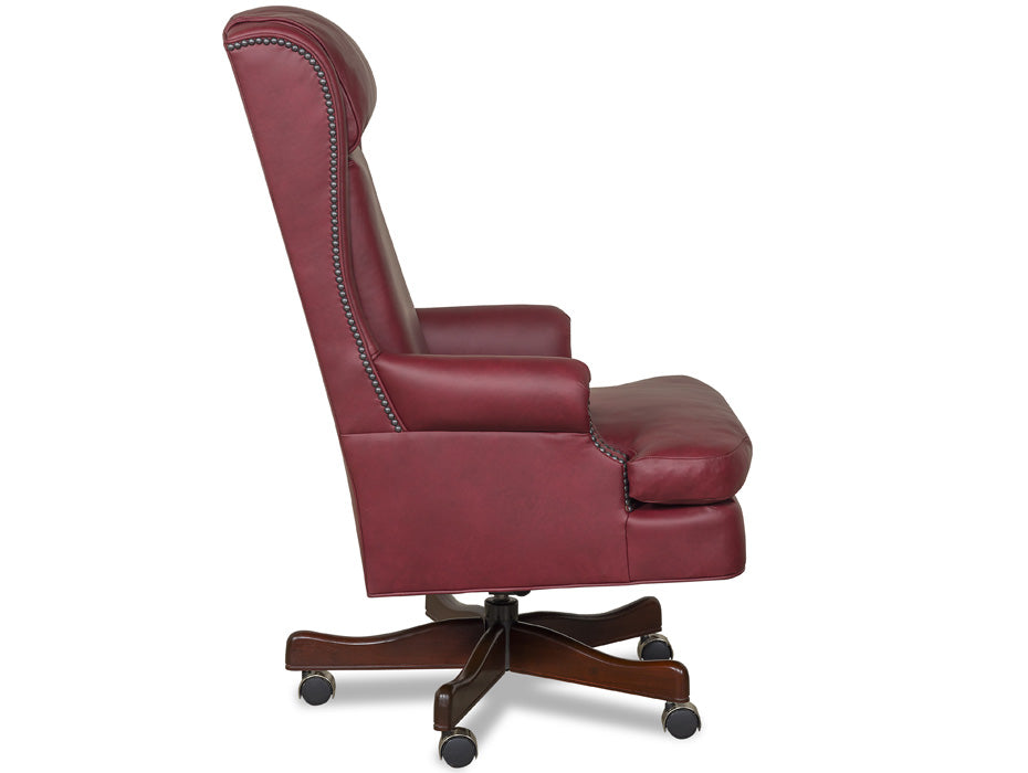 A high-back wingback office chair upholstered in burgundy leather with nailhead trim, shown from the side on a white background.