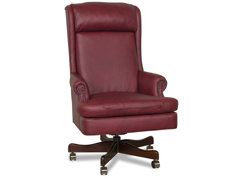 A high-back wingback office chair upholstered in burgundy leather with nailhead trim on the arms, featuring a padded seat and a dark wood five-star swivel base with casters.