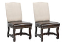Set of two dining chairs with linen fabric backs, leather seats, nail trim, and wood frames