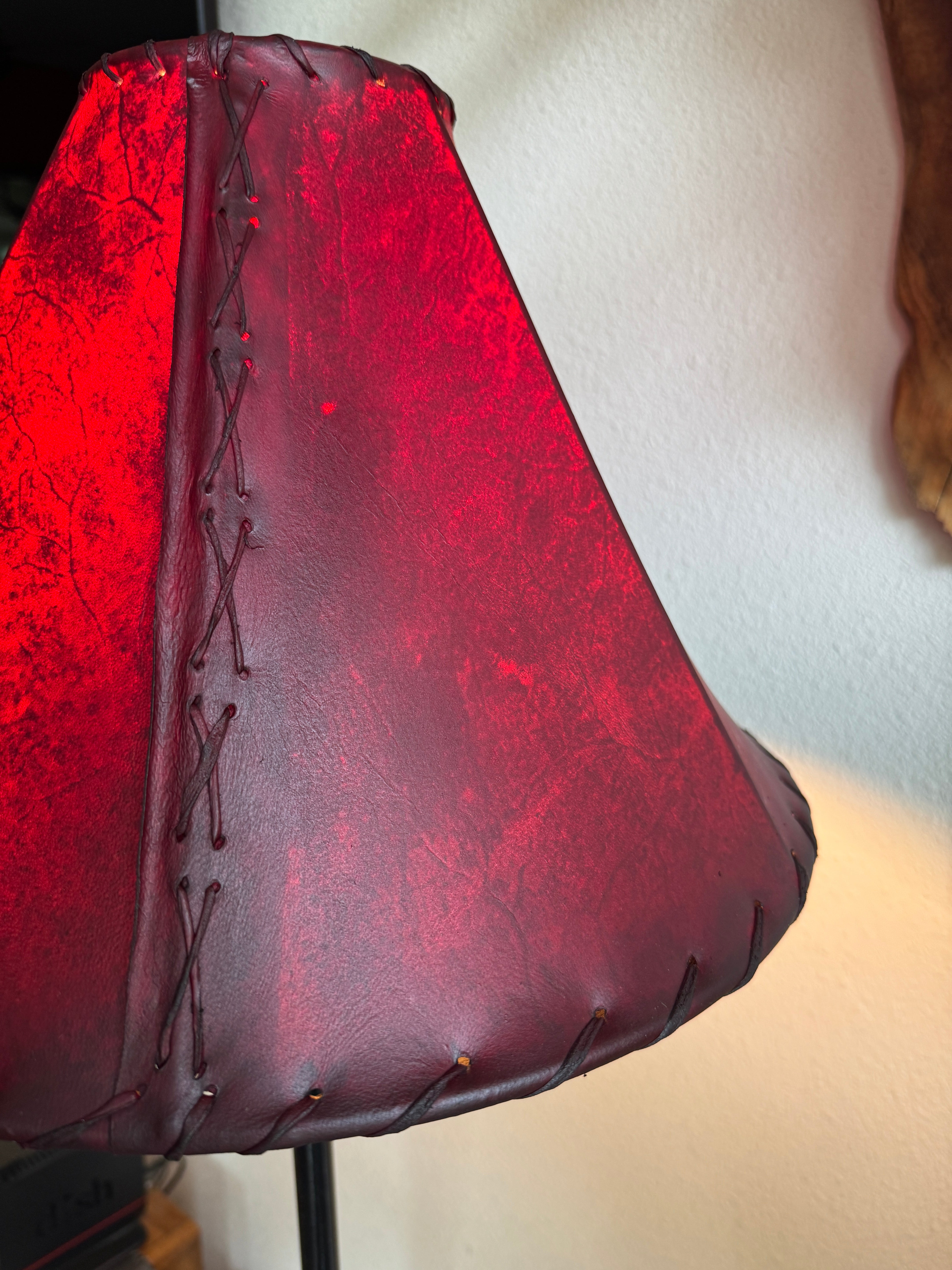 Detail whip stitching on red rawhide leather lamp shade