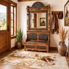 Sierra Grande tooled leather hall tree with longhorn spotted area rug  in Western ranch entryway