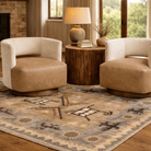 two ivory cowhide and tan leather swivel chairs with rustic wood side table and lamp staged on Pendleton petroglyph southwestern rug in modern ranch living room