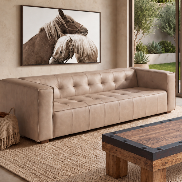 Cream tufted cream leather sofa styled with Haltered Framed Horse Art and a rustic ironbound timber coffee table.