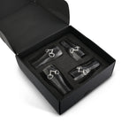 Set of 4 beer glasses with snaffle bit medallion in a black box on a white background