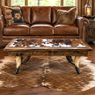 Western living room with leather sofa and steer horn cocktail table with cowhide surface 