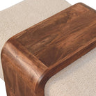Close-up of the Stella Bouclé Cocktail Ottoman highlighting soft cream bouclé texture and richly grained solid mango wood.