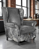 Gray armchair with patterned base in a room with large windows and brick walls - Your Western Decor