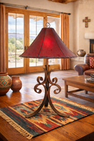 Decorative iron lamp with a red rawhide shade in a living room setting - Your Western Decor