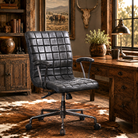 Black leather Teton office chair in a rustic office setting with wooden desk and decor.