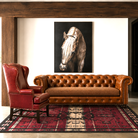 Teton Chesterfield leather sofa in luxury western living room with horse artwork and rustic modern styling