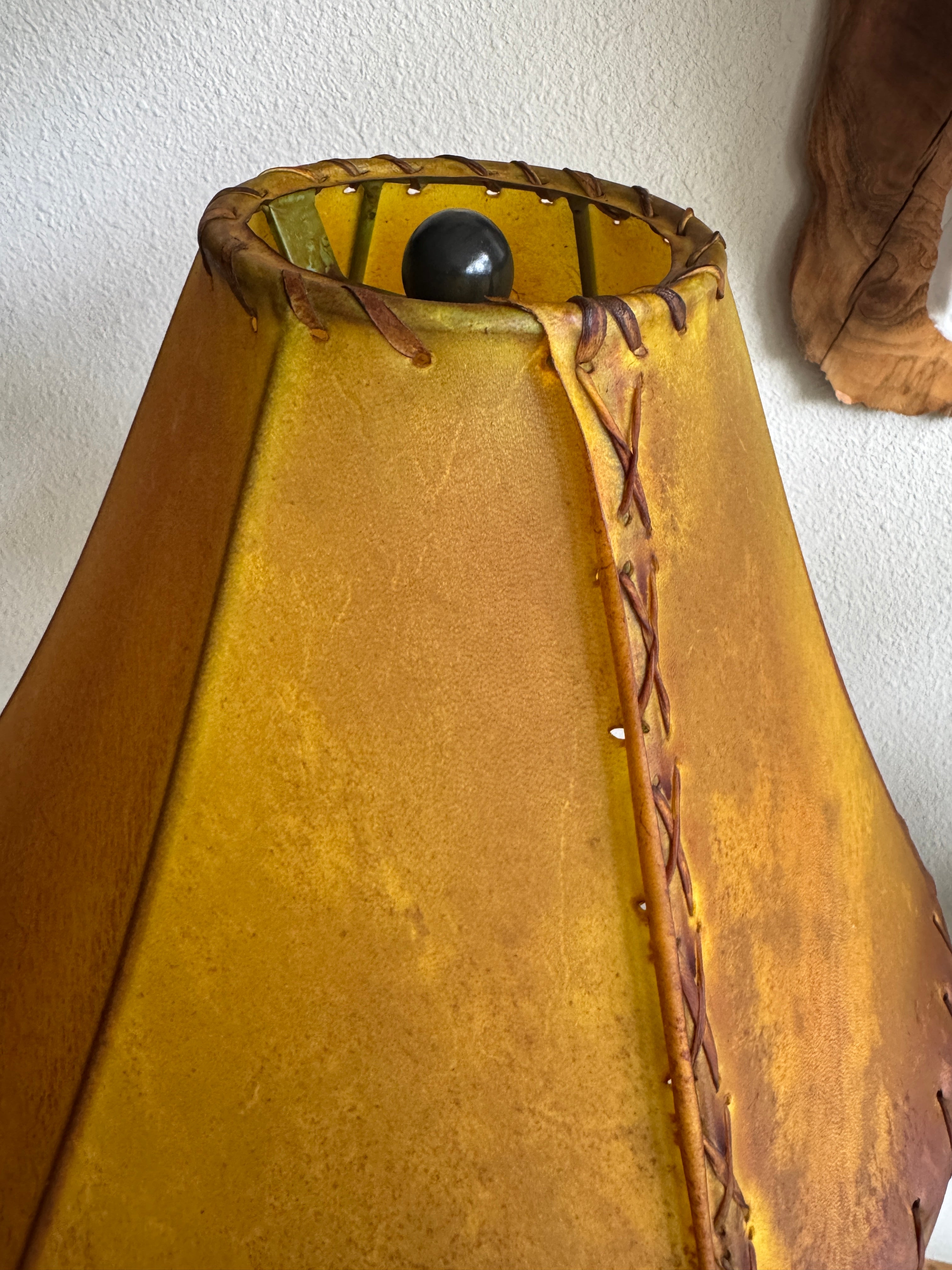 Top view of buckskin color 16-inch round rawhide lamp shade with whip stitching