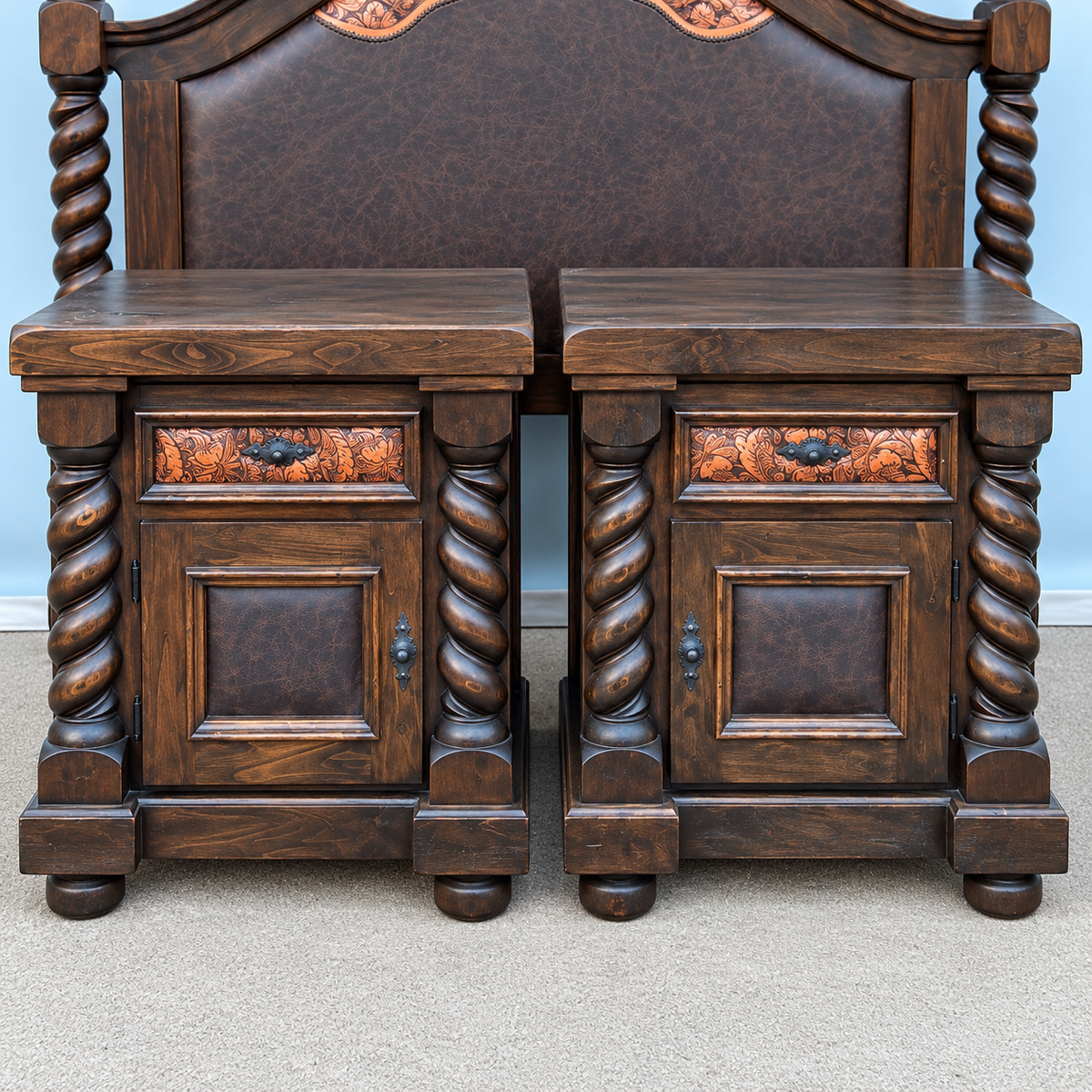 A pair of dark brown wooden nightstands with twisted columns and decorative leather drawer fronts, positioned in front of a matching dark brown leather upholstered headboard.