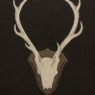 Embroidered design of a deer skull with antlers on a black background