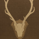 Brown Uncle Buck upholstery fabric featuring repeating stag skull and antler motif, Western lodge style deer pattern fabric for rustic furniture and ranch décor
