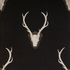 Deer skull design on a black background with antlers.