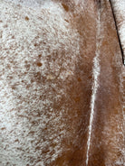 Close up of peppered brown and white cowhide rug